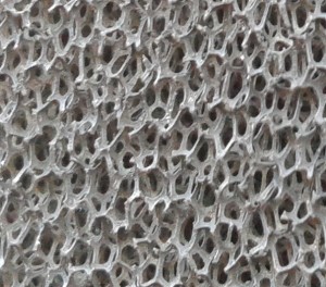 Macro close up of the NiCrAl Metal Alloy Foam. The pores and voids allow for a consistent gas & air mixture flow throughout the burner.